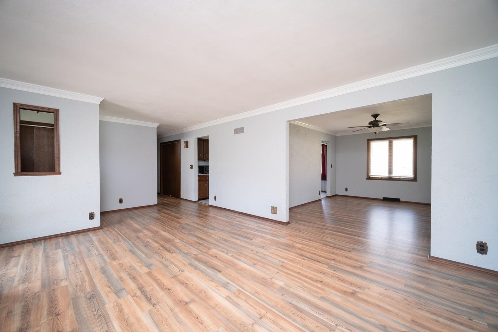 10401 Ray Drive Roscoe, IL 61073 - Photo 11 of 38 an empty room with wooden floor and windows