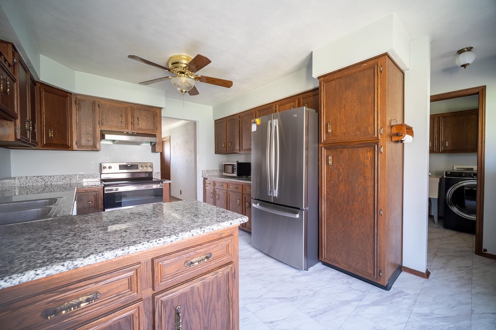 10401 Ray Drive Roscoe, IL 61073 - Photo 18 of 38 a kitchen with granite countertop a refrigerator a sink and dishwasher