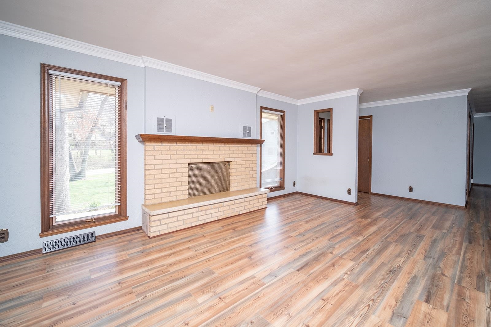 10401 Ray Drive Roscoe, IL 61073 - Photo 9 of 38 an empty room with wooden floor fireplace and windows
