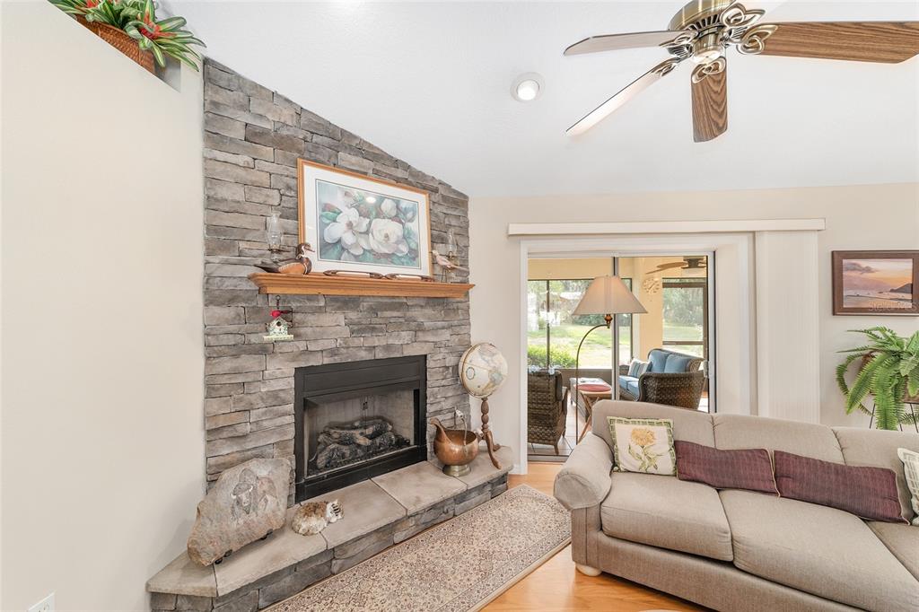2320 Southeast 33rd Street Ocala, FL 34471 - Photo 16 of 67 a living room with furniture a window and a fireplace