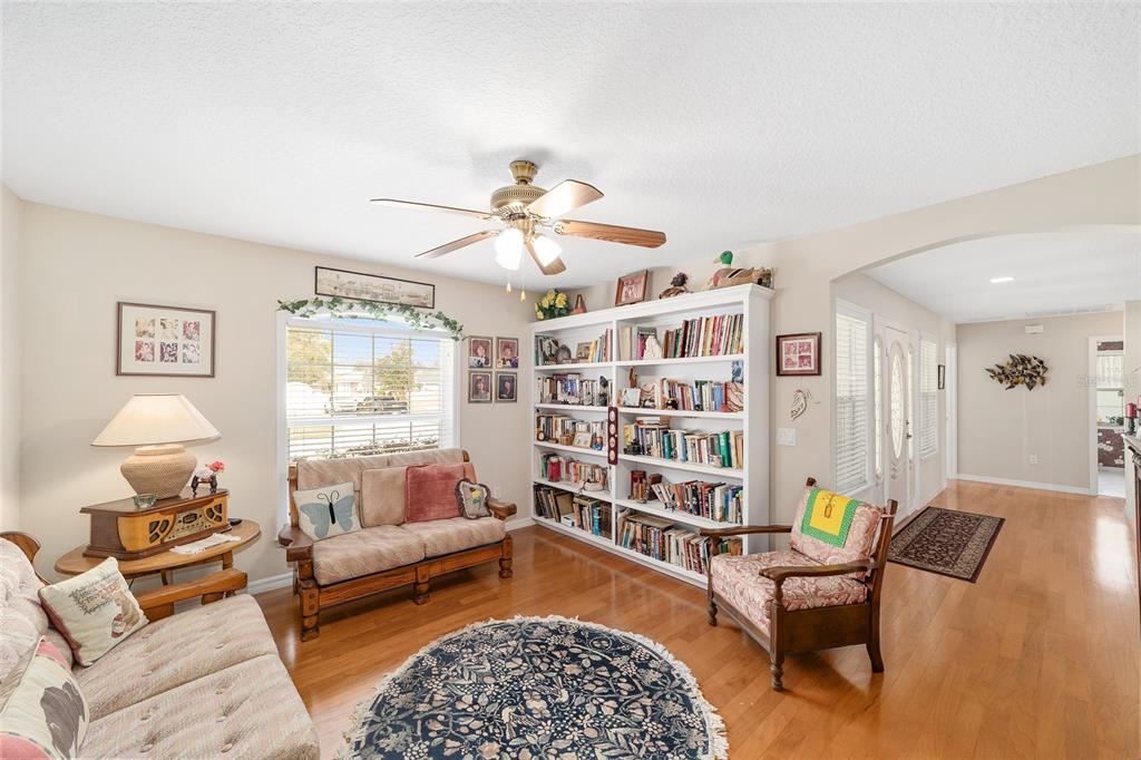 2320 Southeast 33rd Street Ocala, FL 34471 - Photo 18 of 67 a living room with furniture and a book shelf