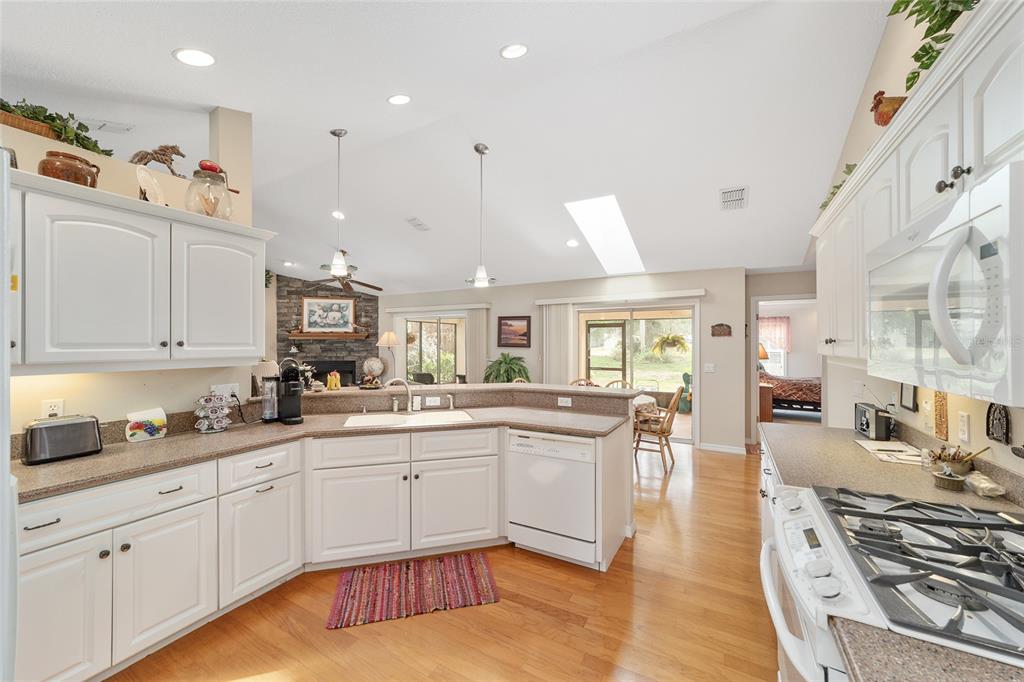 2320 Southeast 33rd Street Ocala, FL 34471 - Photo 23 of 67 a large white kitchen with lots of counter space and sink