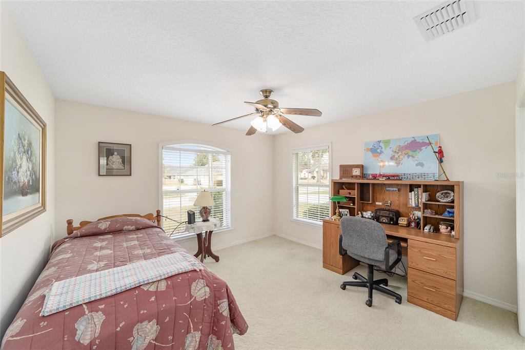 2320 Southeast 33rd Street Ocala, FL 34471 - Photo 34 of 67 a bedroom with a bed and a chandelier