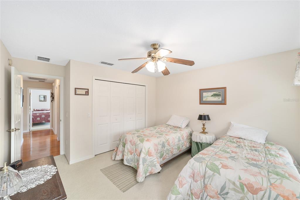 2320 Southeast 33rd Street Ocala, FL 34471 - Photo 38 of 67 a bedroom with two beds and a chandelier