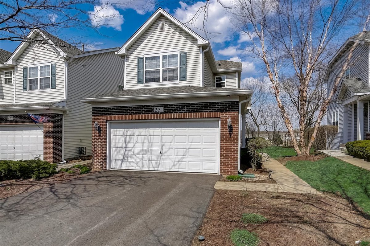 231 Ridge Road North Aurora, IL 60542 - Photo 1 of 31 a front view of a house with a yard and garage
