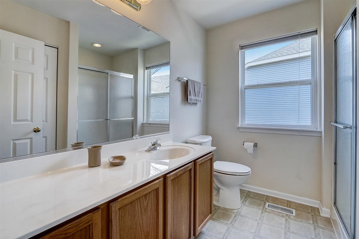 231 Ridge Road North Aurora, IL 60542 - Photo 22 of 31 a bathroom with a sink a toilet and shower