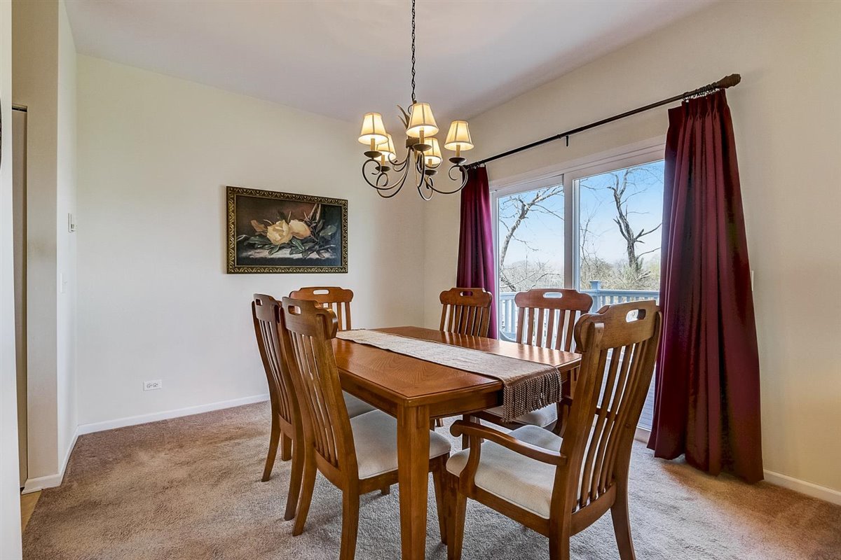 231 Ridge Road North Aurora, IL 60542 - Photo 5 of 31 a view of a dining room with furniture a chandelier and wooden floor