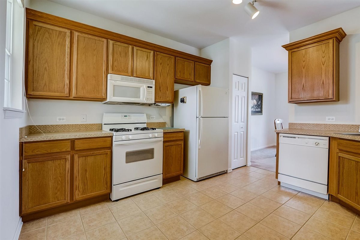 231 Ridge Road North Aurora, IL 60542 - Photo 8 of 31 a kitchen with a stove top oven sink and a refrigerator