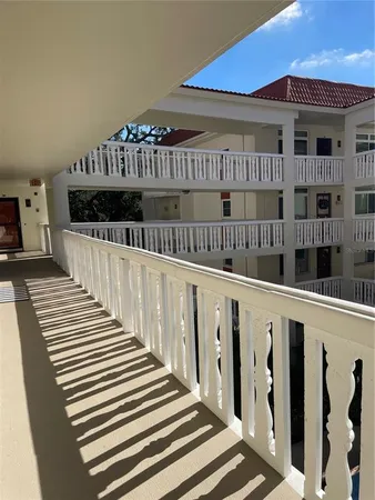 a view of a balcony with wooden floor