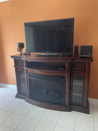a living room with a fireplace and a flat screen tv