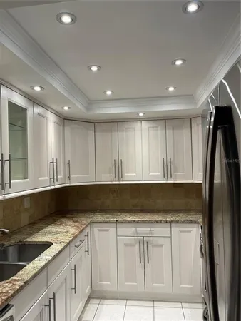 a kitchen with granite countertop white cabinets and a granite counter tops