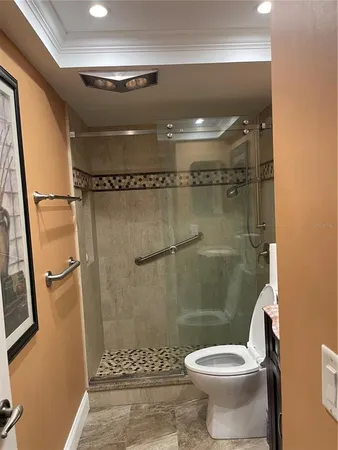 a bathroom with a toilet and a shower