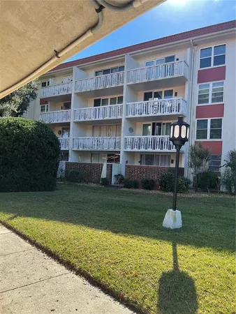 a backyard of a house with lots of trees and plants