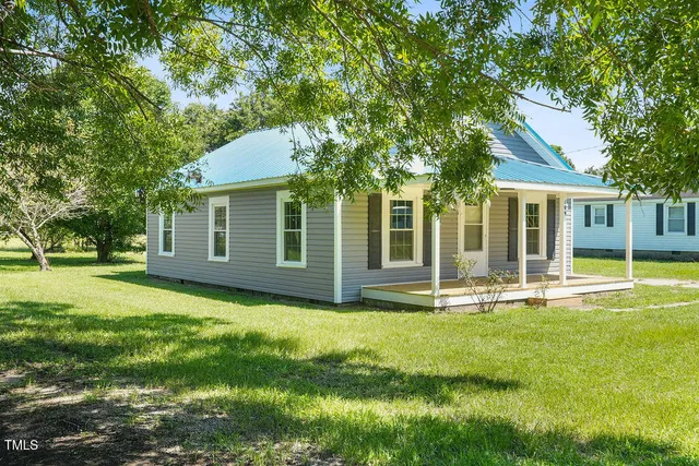 a house that has a big yard in front of it