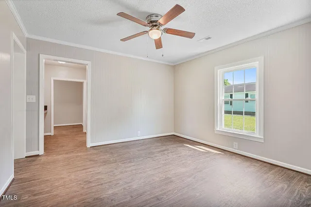 wooden floor in an empty room with a window