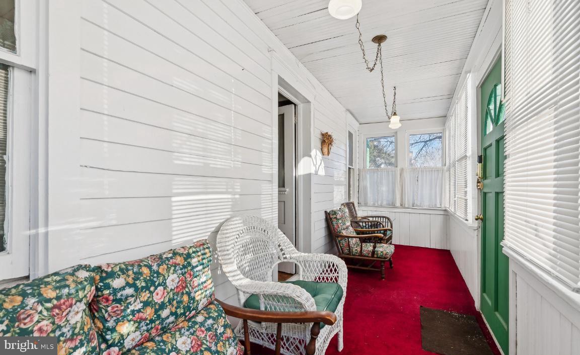 361 Democrat Road Gibbstown, NJ 08027 - Photo 2 of 12 Charming sunlit porch with vibrant decor.