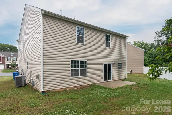 a view of a house with a backyard