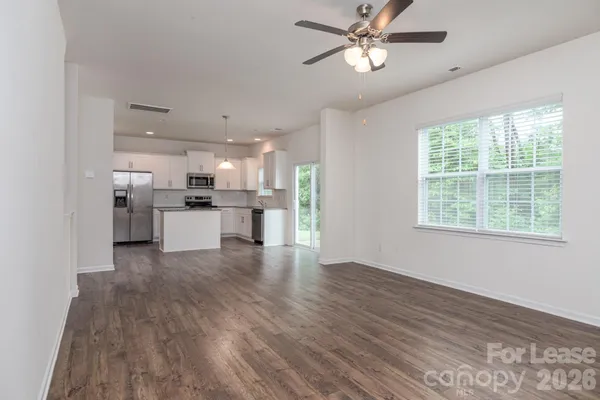 a view of kitchen with wooden floor electronic appliances and window