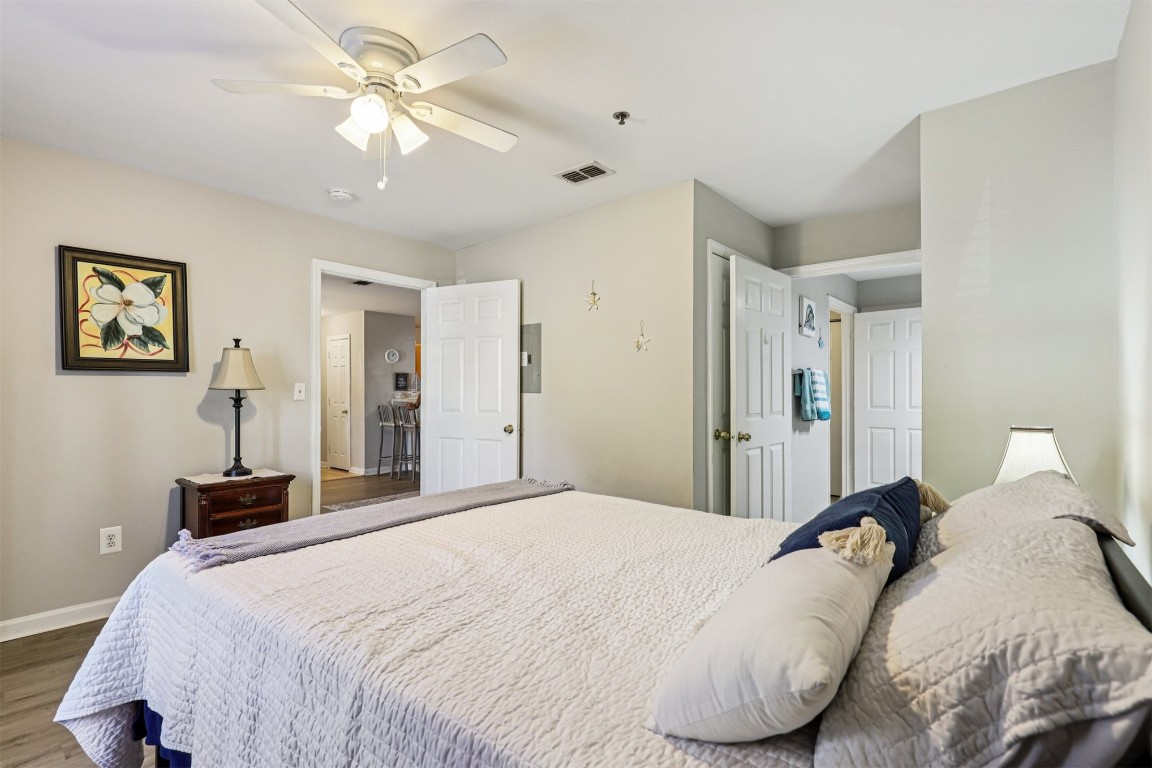 31183 Paradise Cmns, Unit 713 Fernandina Beach, FL 32034 - Photo 19 of 35 a bedroom with a large bed and a chandelier
