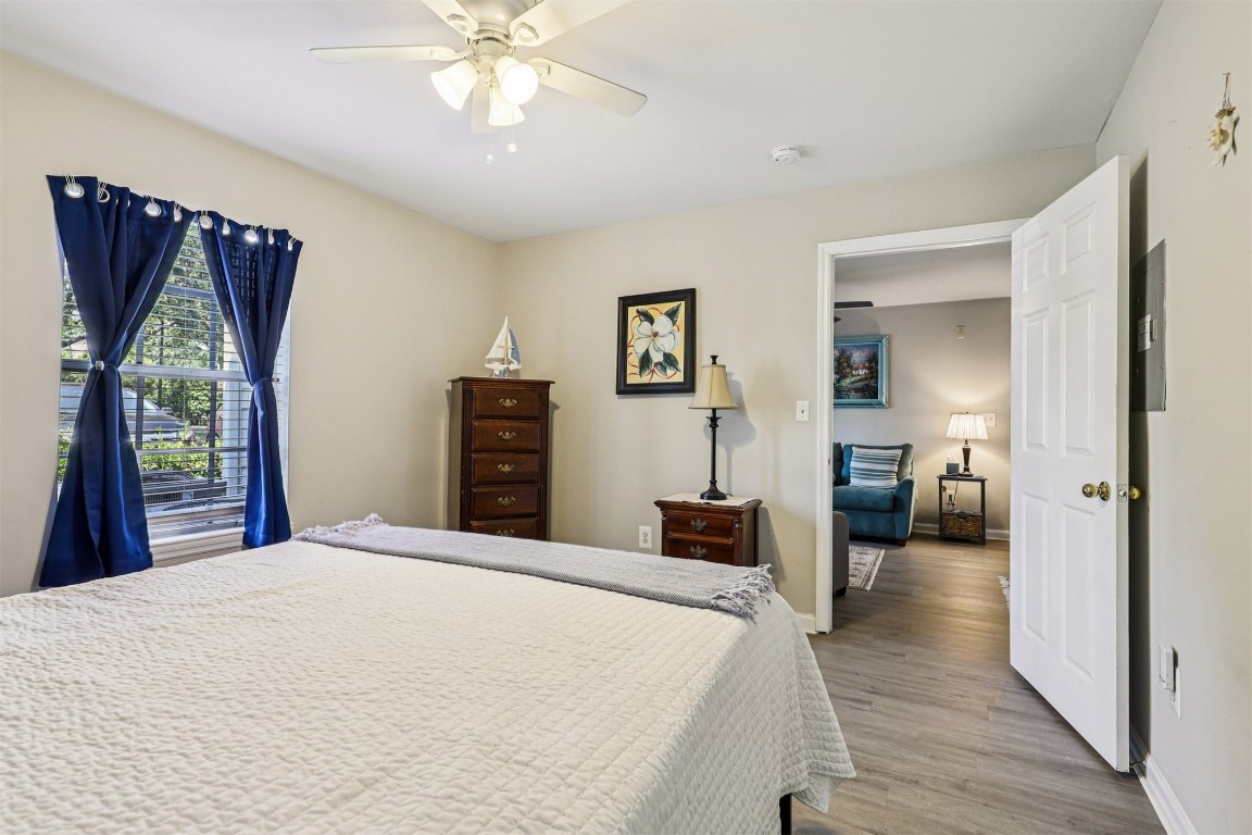 31183 Paradise Cmns, Unit 713 Fernandina Beach, FL 32034 - Photo 20 of 35 a bedroom with a large bed and a chandelier