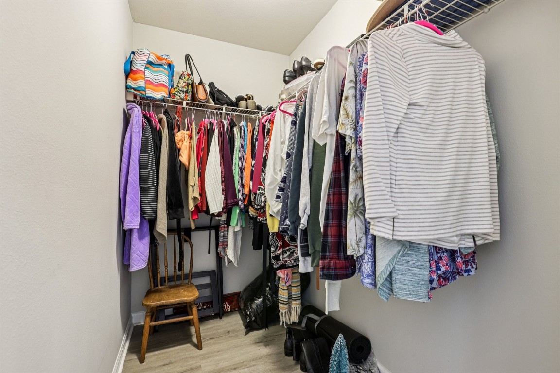 31183 Paradise Cmns, Unit 713 Fernandina Beach, FL 32034 - Photo 23 of 35 a view of walk in closet with clothes and shoes