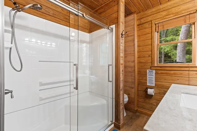 a bathroom with a glass shower door
