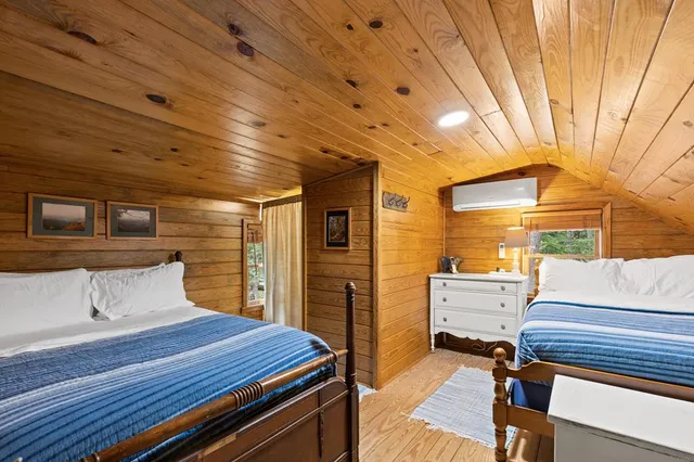 a bedroom with furniture and wooden floor