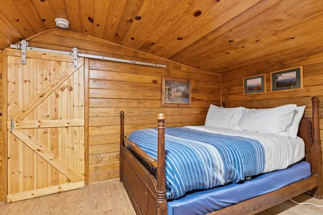 a bedroom with bed and balcony