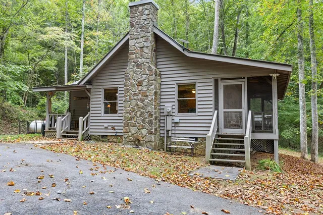 a view of a house with a yard and wooden fence