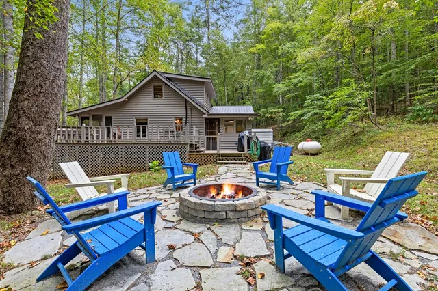 a view of a chairs and table in backyard of the house