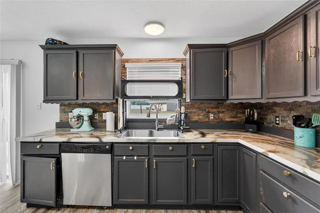 a kitchen with a sink and wooden cabinets