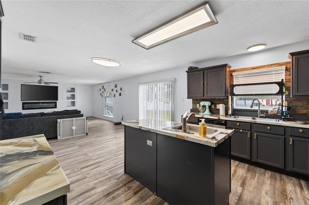 10325 Frog Pond Drive Riverview, FL 33569 - Photo 15 of 53 a kitchen with a sink and wooden cabinets