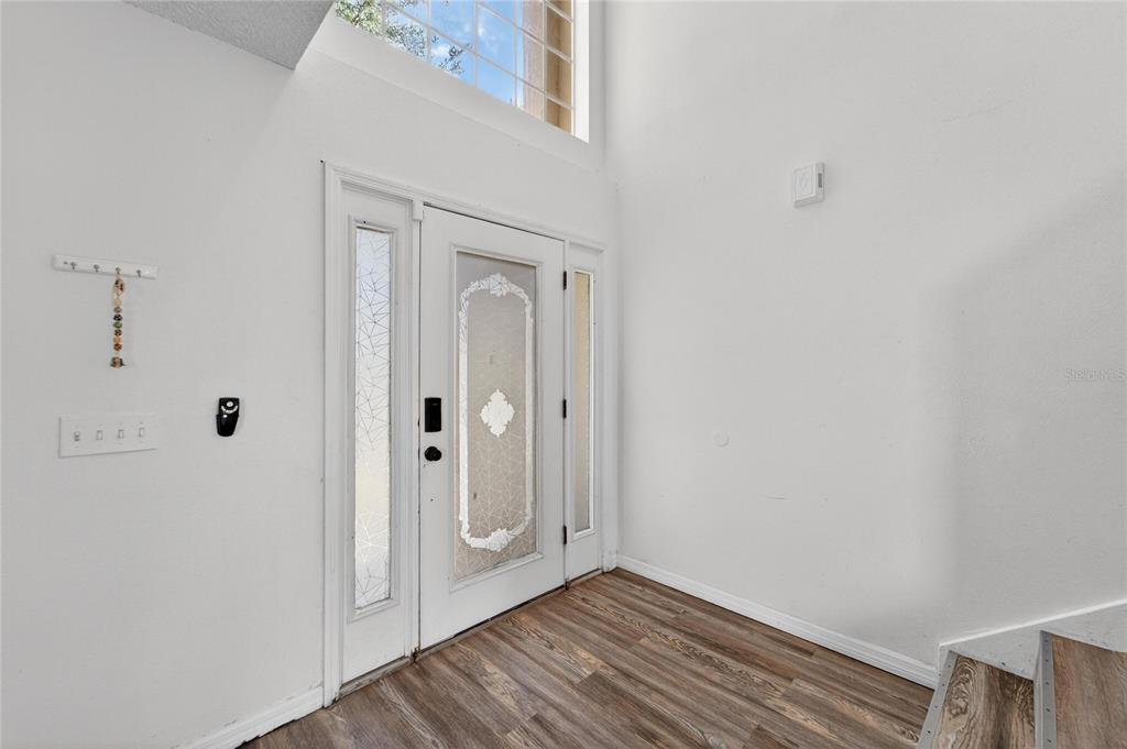 10325 Frog Pond Drive Riverview, FL 33569 - Photo 2 of 53 a view of a hallway with wooden floor