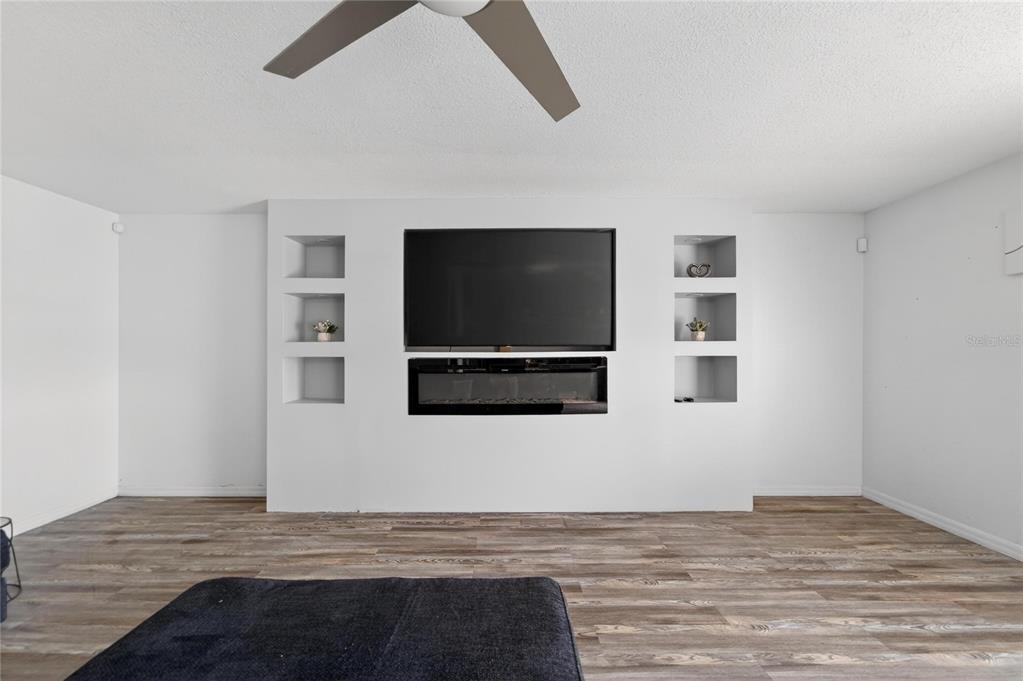 10325 Frog Pond Drive Riverview, FL 33569 - Photo 21 of 53 a view of a livingroom with wooden floor and a flat screen tv