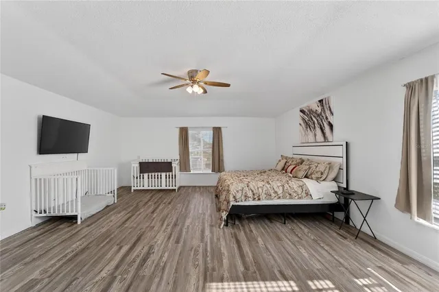 a bedroom with a bed and a chandelier