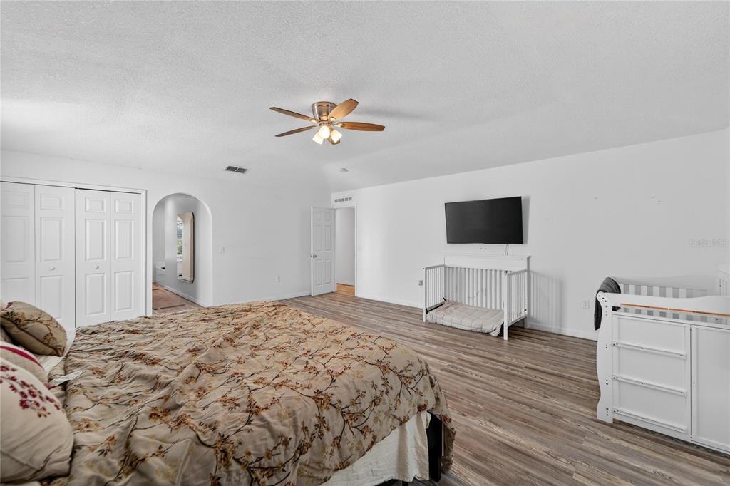 10325 Frog Pond Drive Riverview, FL 33569 - Photo 27 of 53 a bedroom with a bed and a flat screen tv