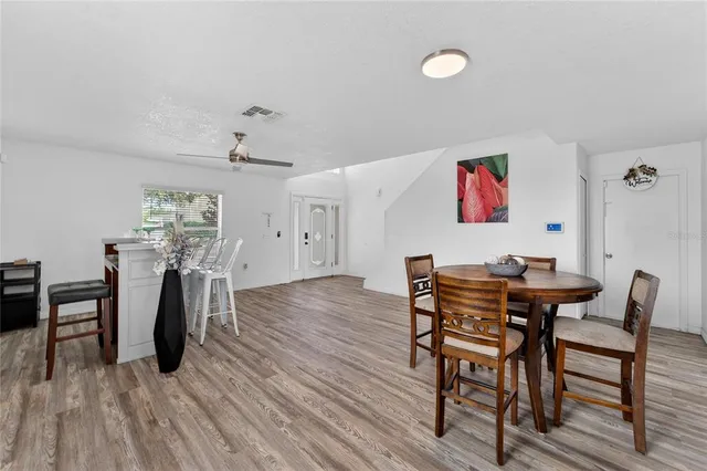 a view of a dining room with furniture and wooden floor