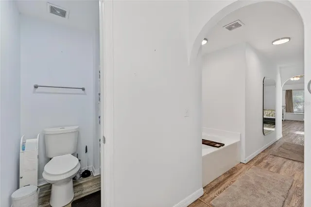 a bathroom with a sink vanity and a toilet