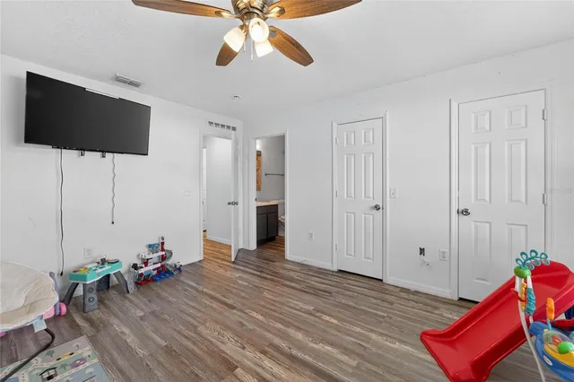 a bed room with a bed and a chair