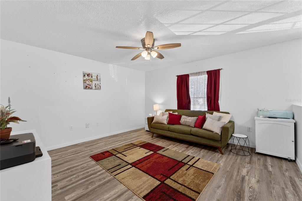 10325 Frog Pond Drive Riverview, FL 33569 - Photo 43 of 53 a living room with furniture and a rug