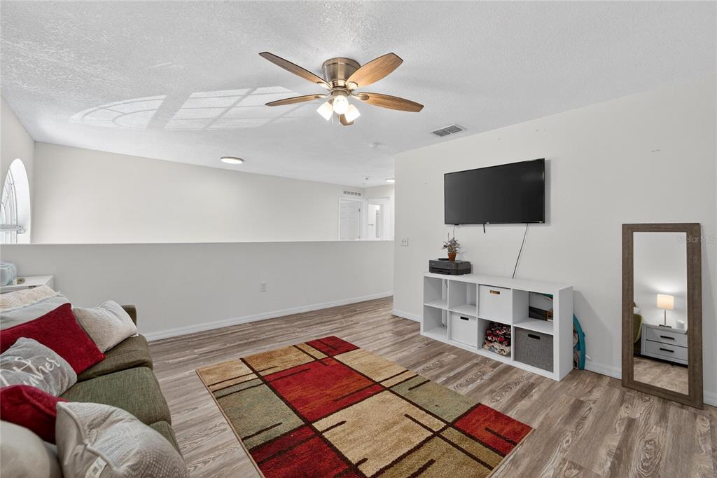 10325 Frog Pond Drive Riverview, FL 33569 - Photo 44 of 53 a living room with furniture and a flat screen tv