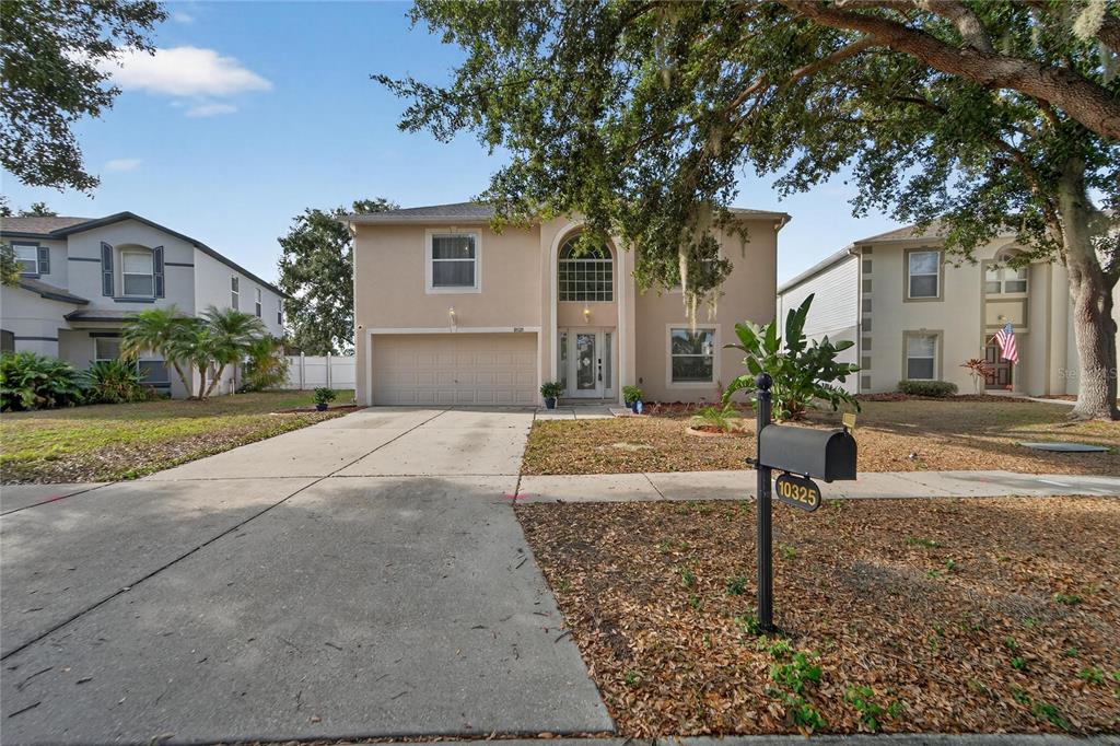 10325 Frog Pond Drive Riverview, FL 33569 - Photo 46 of 53 a front view of a house with a yard and garage