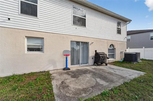 an aerial view of residential houses with outdoor space and trees