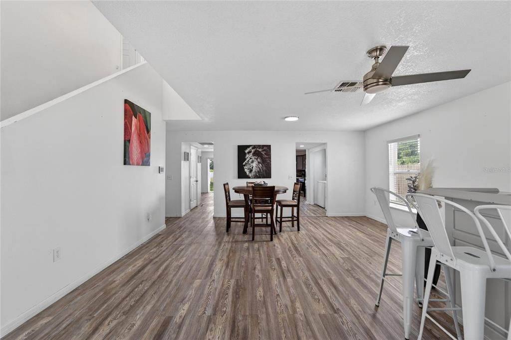 10325 Frog Pond Drive Riverview, FL 33569 - Photo 6 of 53 a view of a dining room with furniture and wooden floor