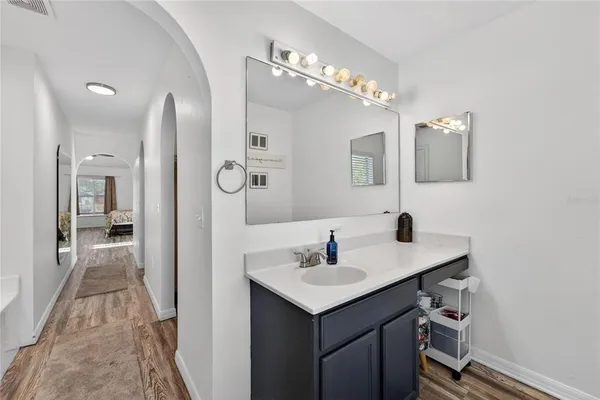 a en suite bathroom with a sink mirror and vanity