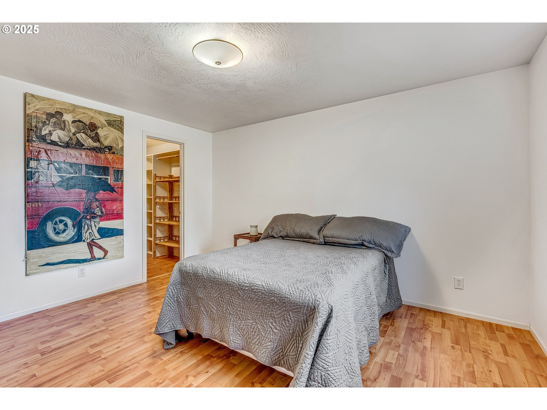 970 West L Street Springfield, OR 97477 - Photo 19 of 23 a bedroom with a bed and painting on the wall