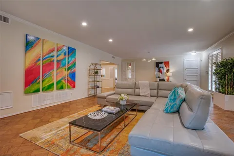 a living room with furniture and painting on the wall