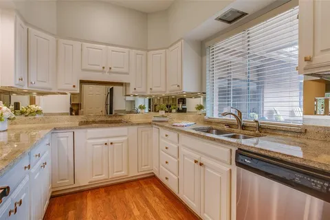 a kitchen with sink cabinets and window