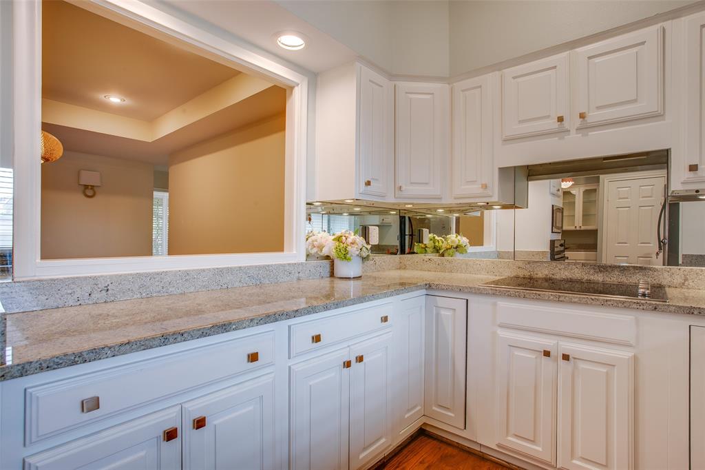 6314 Bandera Avenue, Unit C Dallas, TX 75225 - Photo 20 of 40 a kitchen with stainless steel appliances granite countertop a sink a stove and white cabinets with wooden floor