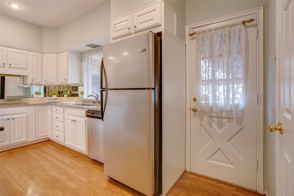 6314 Bandera Avenue, Unit C Dallas, TX 75225 - Photo 21 of 40 a kitchen with white cabinets and white appliances